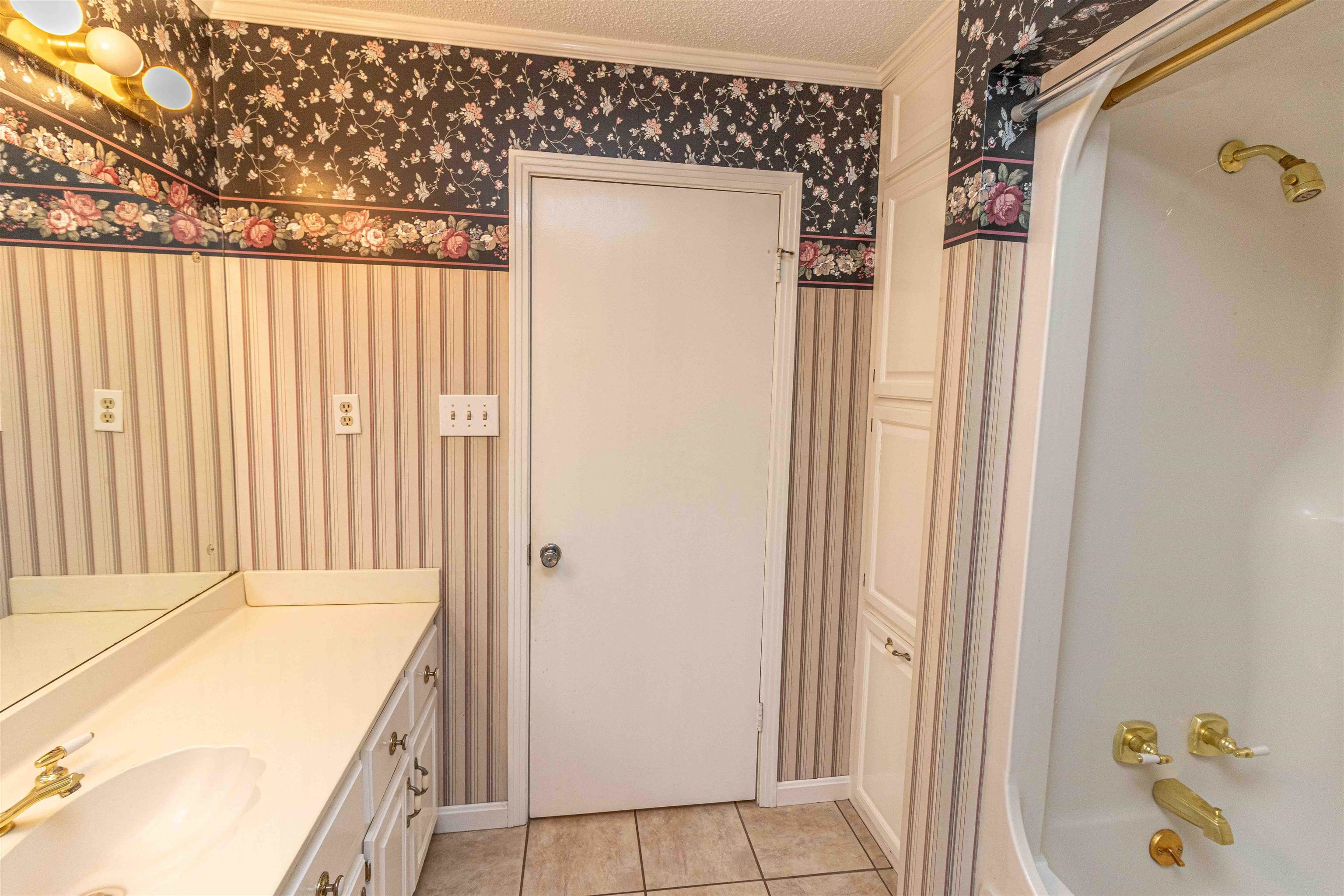 239 Old Road South, Unit 5 Selmer, TN 38375 - Photo 22 of 34 a bathroom with a tub and shower