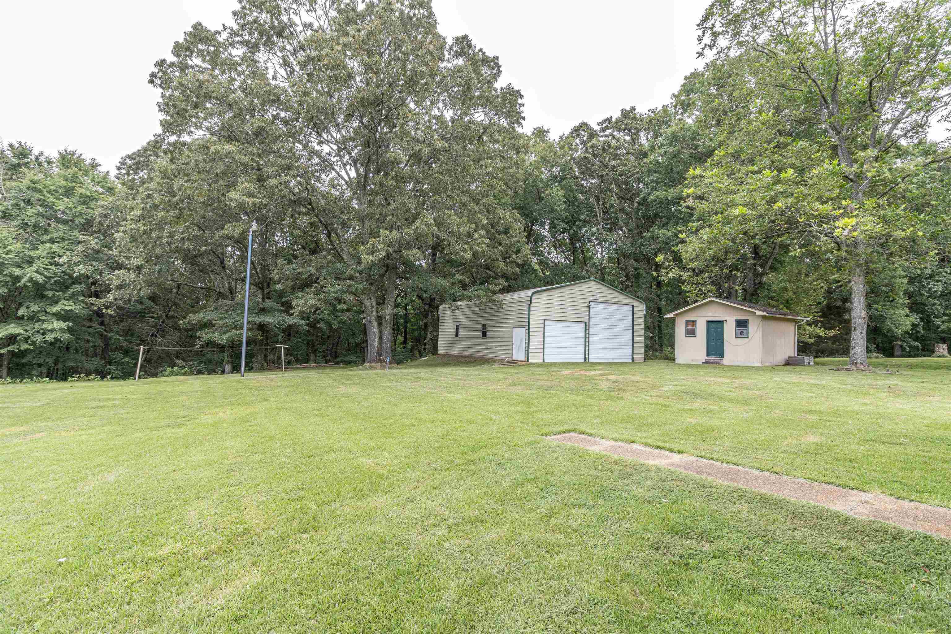 239 Old Road South, Unit 5 Selmer, TN 38375 - Photo 29 of 34 a house with a big yard with large trees