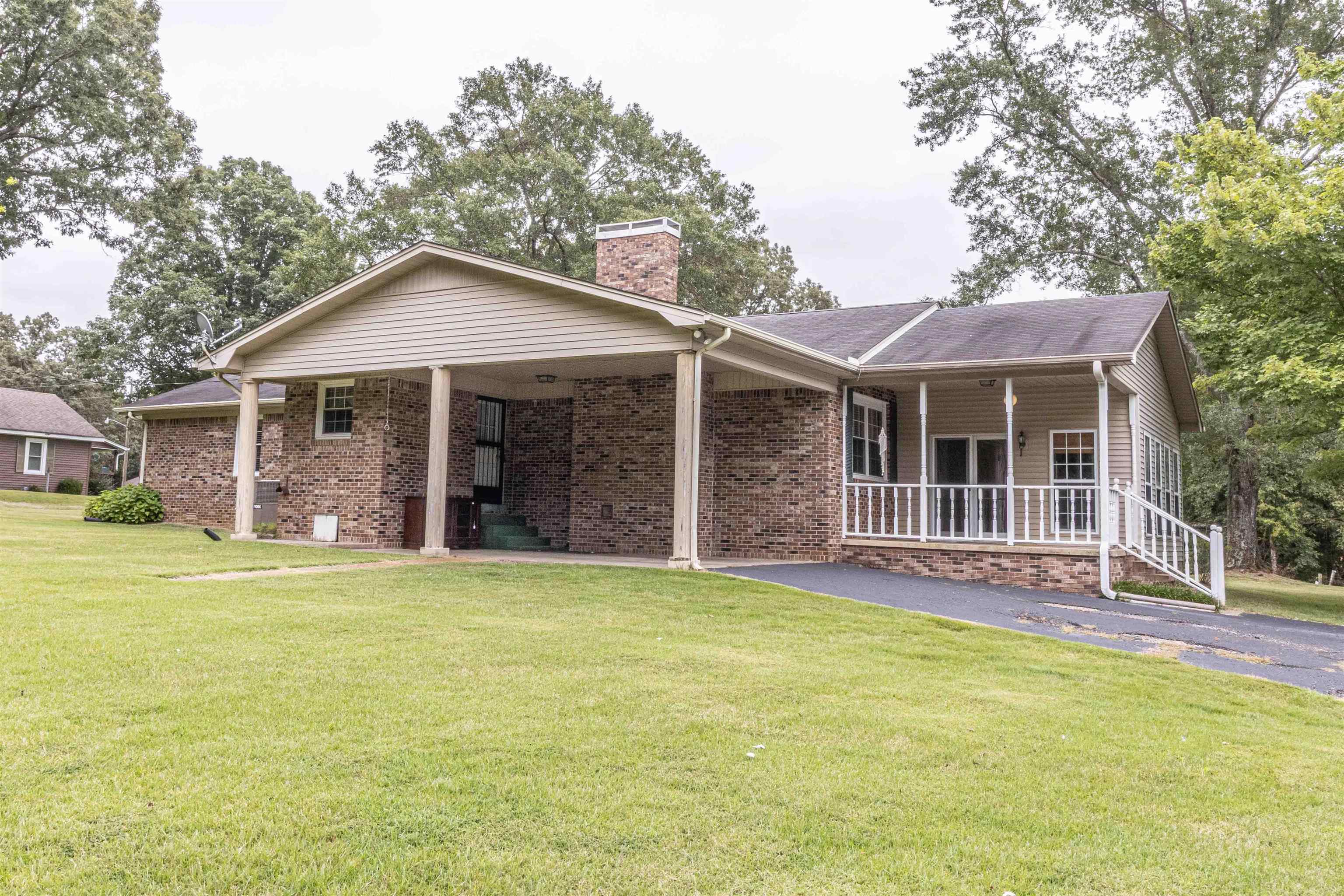 239 Old Road South, Unit 5 Selmer, TN 38375 - Photo 30 of 34 a front view of a house with a garden and porch