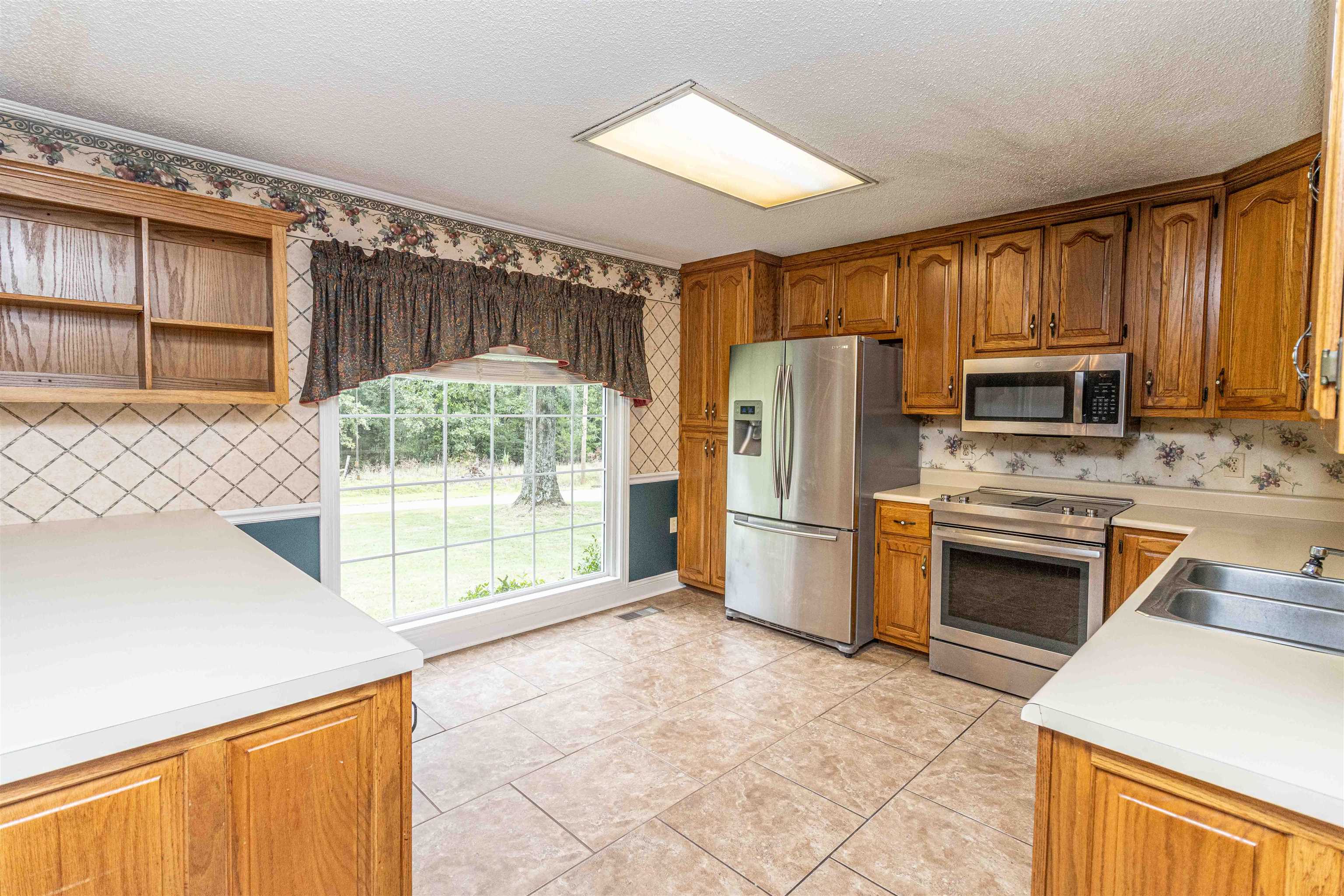 239 Old Road South, Unit 5 Selmer, TN 38375 - Photo 7 of 34 a kitchen with stainless steel appliances a stove a refrigerator and a sink