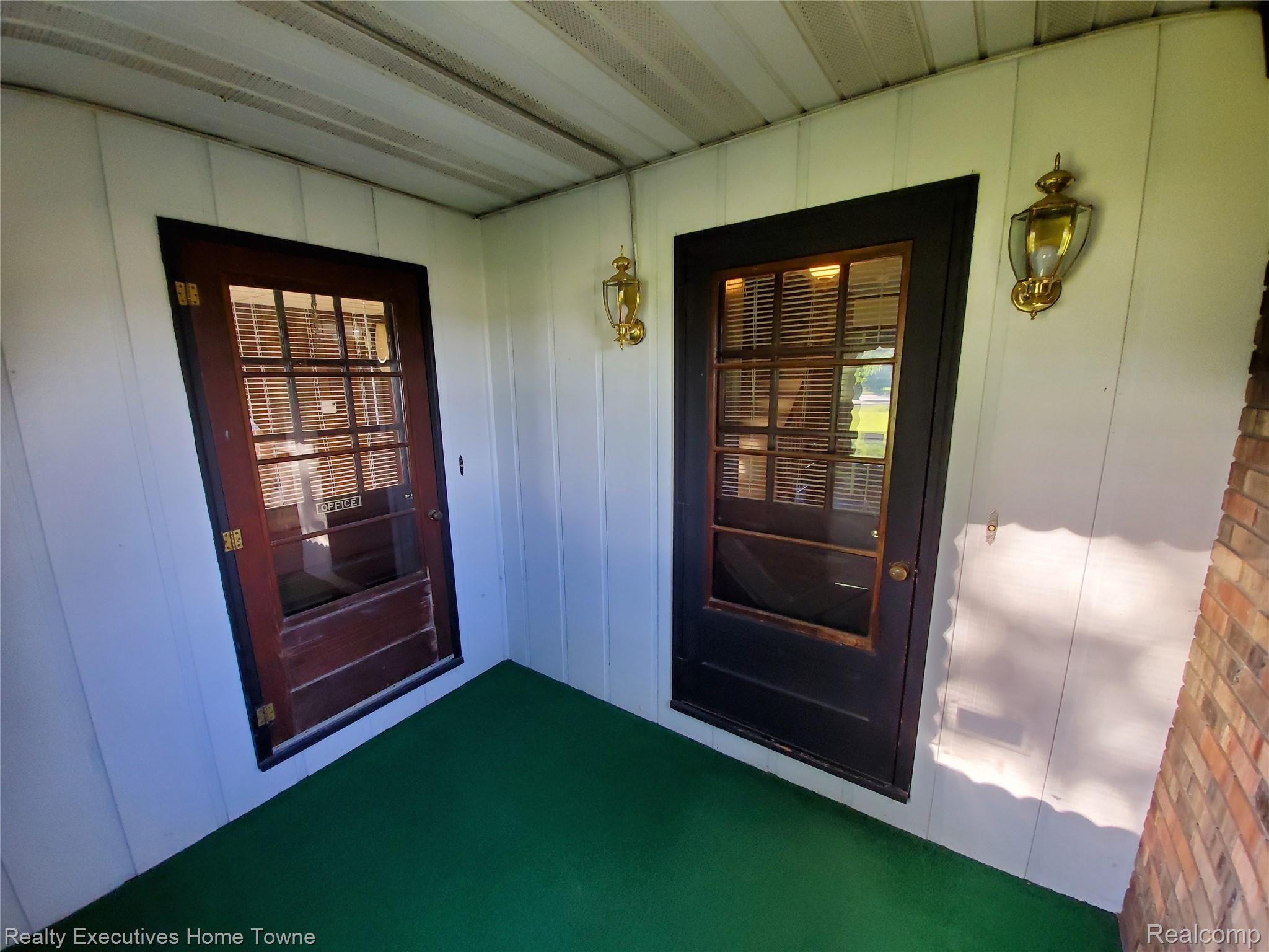 7864 Wildcat Road Jeddo, MI 48032 - Photo 7 of 39 Dual entries off enclosed front porch. One to office and one to house.