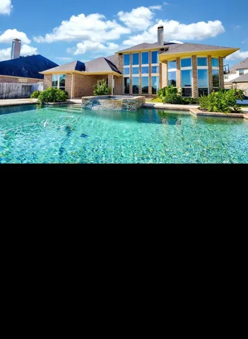 a view of an empty room with a kitchen