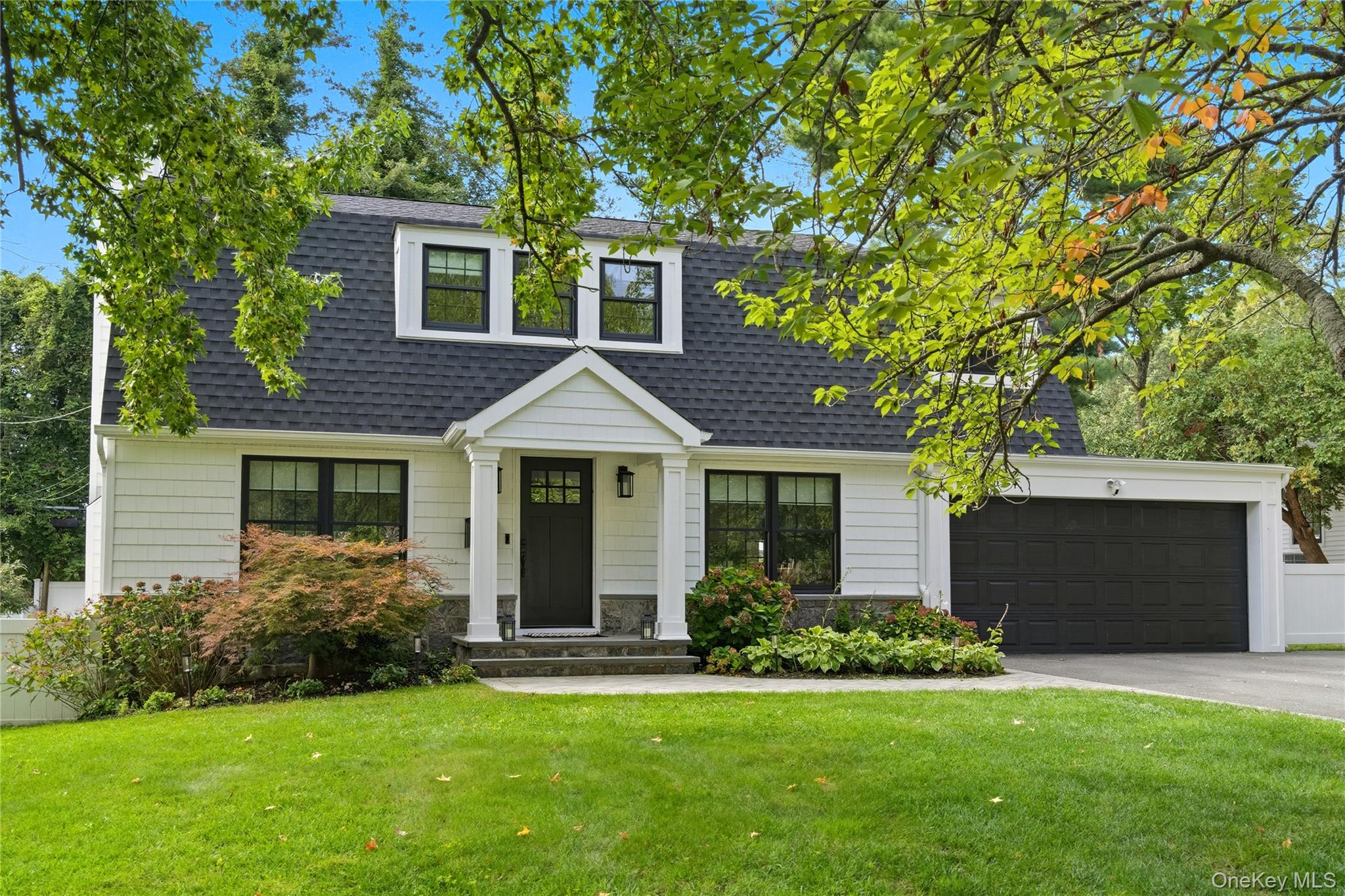17 Entrance Road East Hills, NY 11577 - Photo 1 of 30 a front view of a house with a yard and garage
