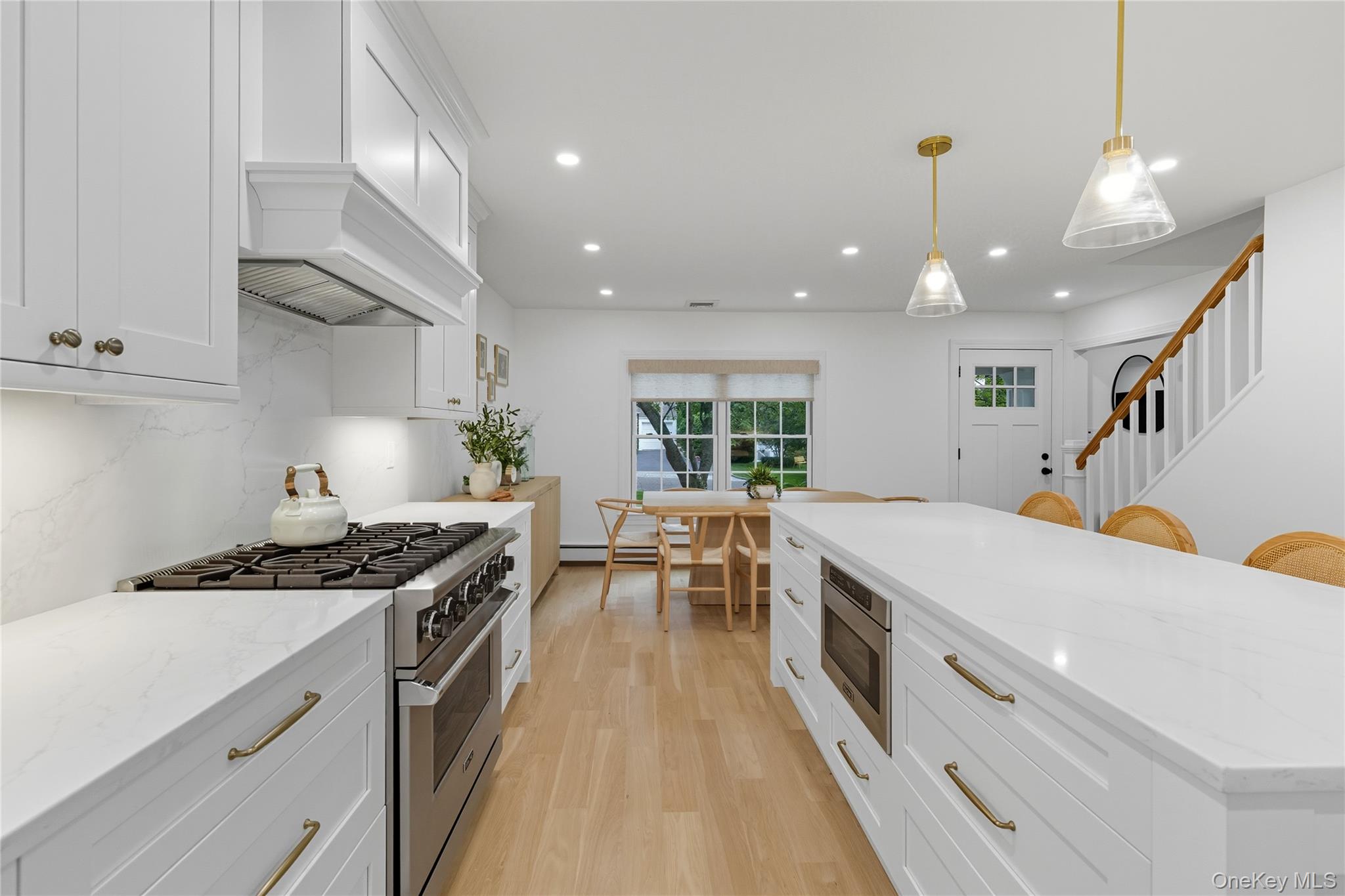 17 Entrance Road East Hills, NY 11577 - Photo 11 of 30 a kitchen with stainless steel appliances a stove a sink a counter top space and cabinets
