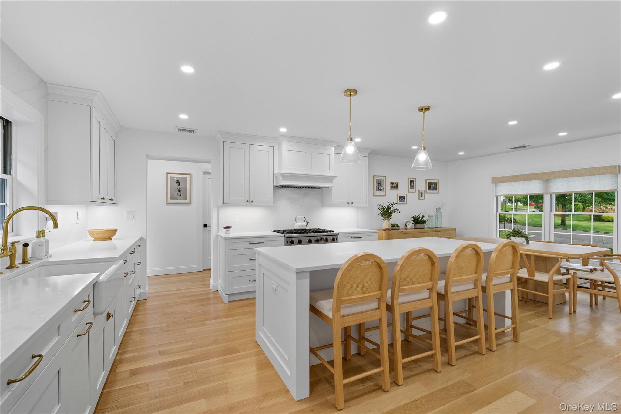 17 Entrance Road East Hills, NY 11577 - Photo 12 of 30 a large kitchen with stainless steel appliances granite countertop a stove a sink a dining table and chairs