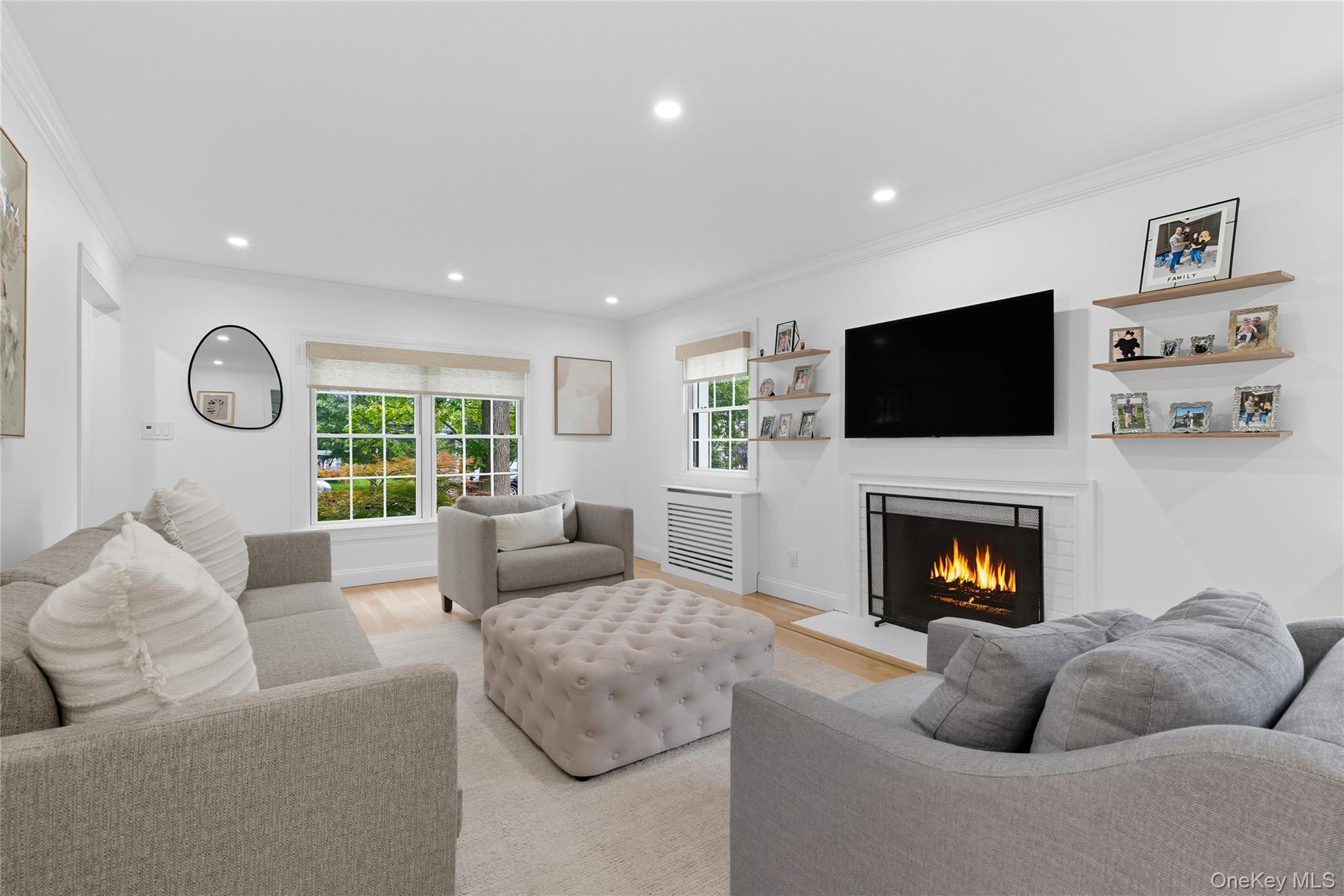 17 Entrance Road East Hills, NY 11577 - Photo 14 of 30 a living room with furniture flat screen tv and a fireplace