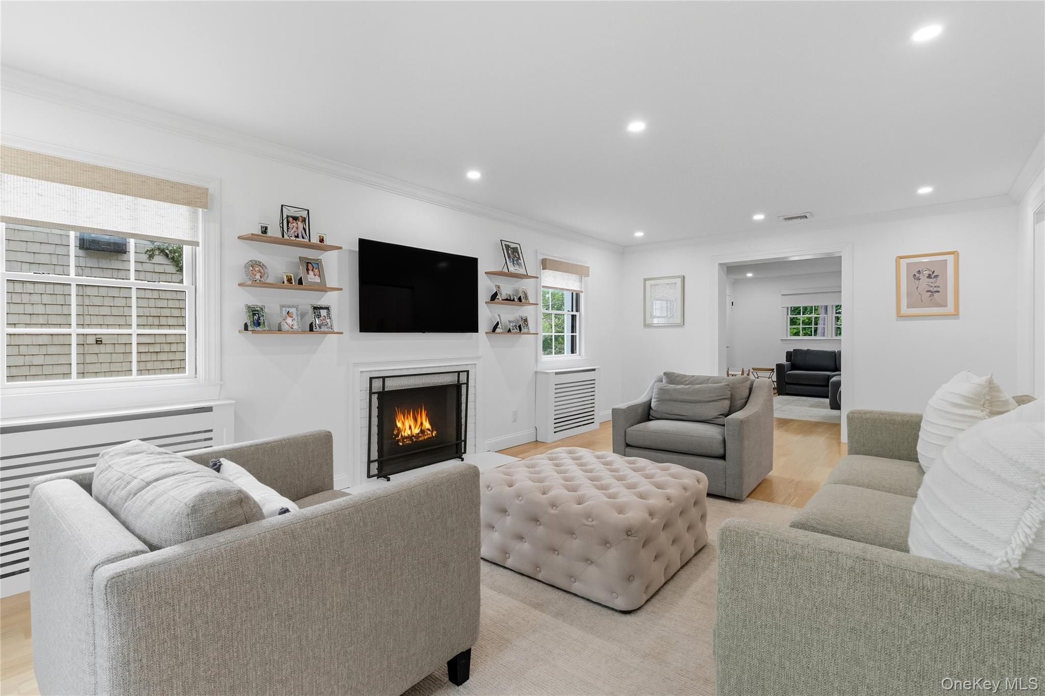 17 Entrance Road East Hills, NY 11577 - Photo 15 of 30 a living room with furniture a fireplace and a flat screen tv