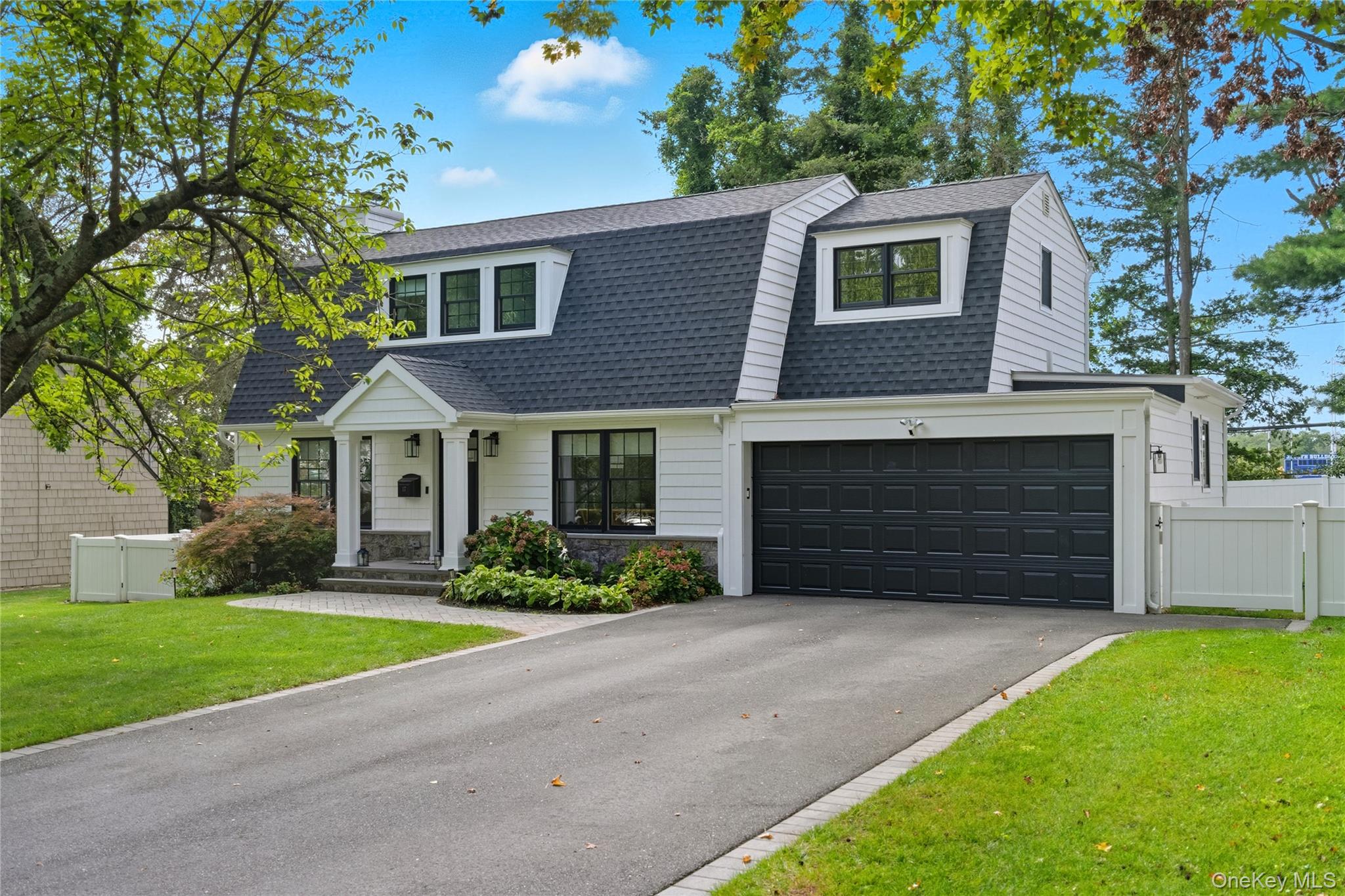 17 Entrance Road East Hills, NY 11577 - Photo 2 of 30 a front view of a house with a yard and garage