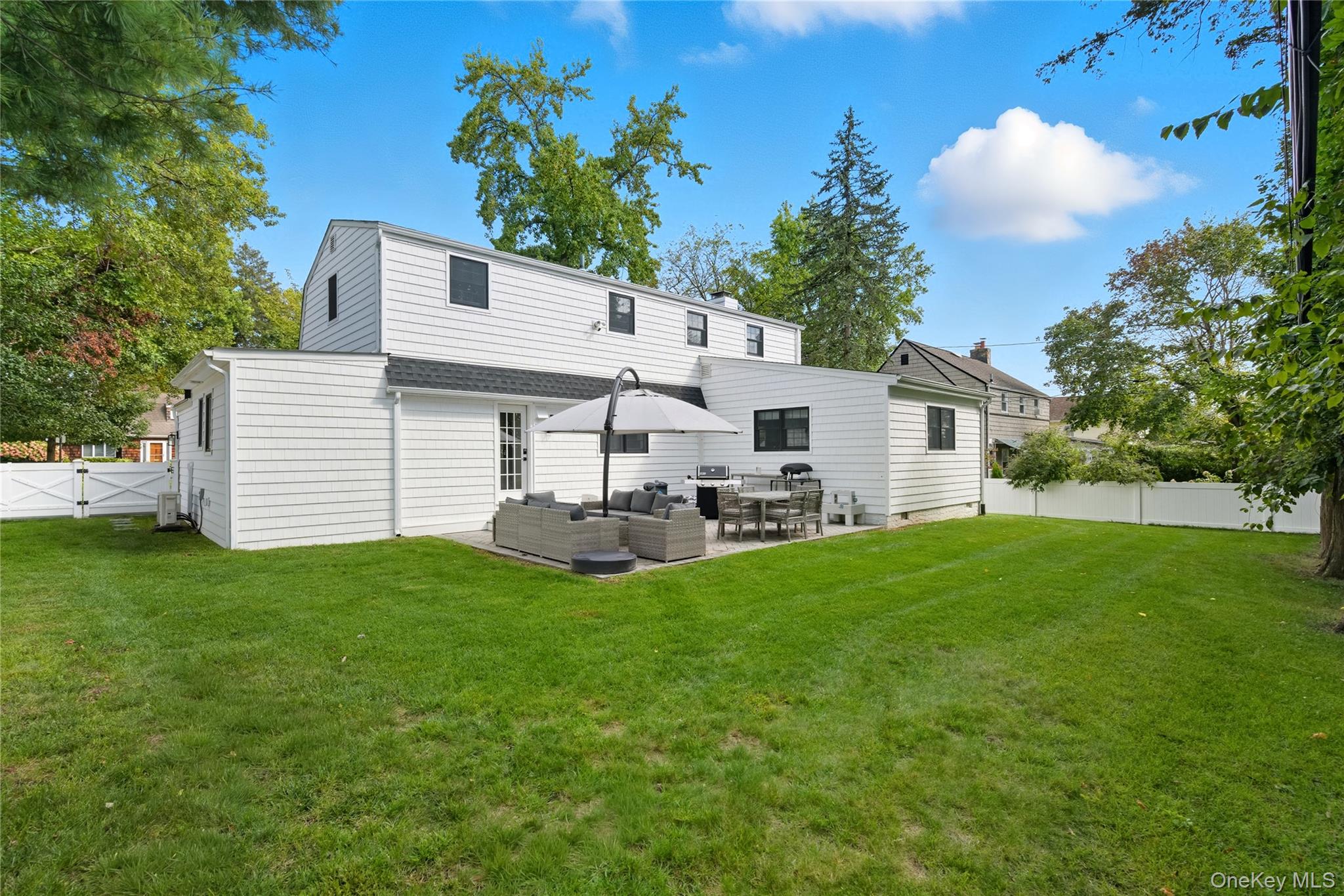 17 Entrance Road East Hills, NY 11577 - Photo 28 of 30 a view of a white house with a yard and sitting area