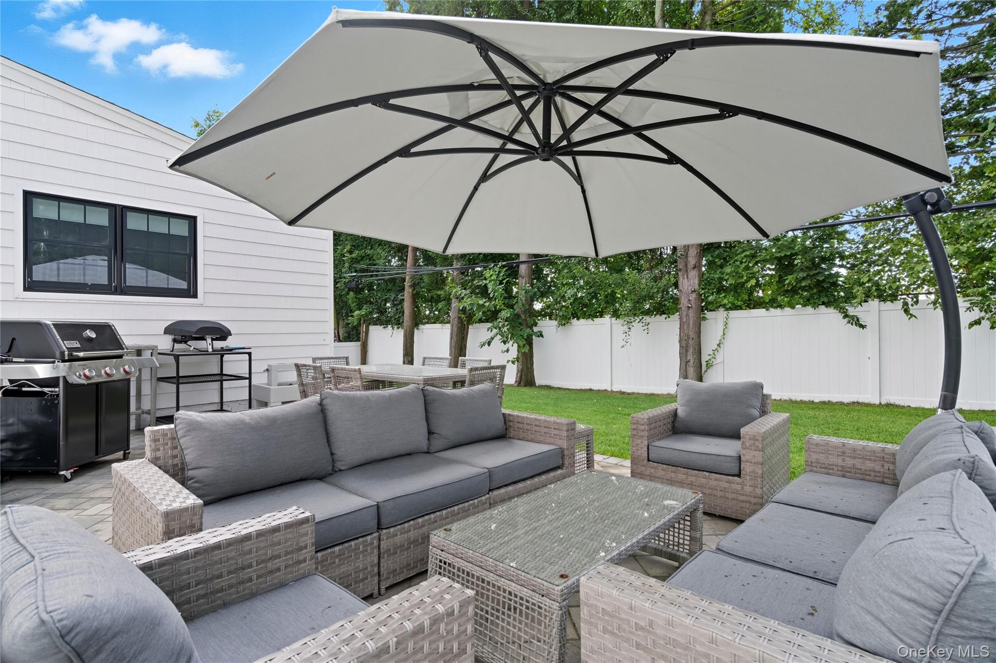 17 Entrance Road East Hills, NY 11577 - Photo 30 of 30 a backyard of a house with table and chairs
