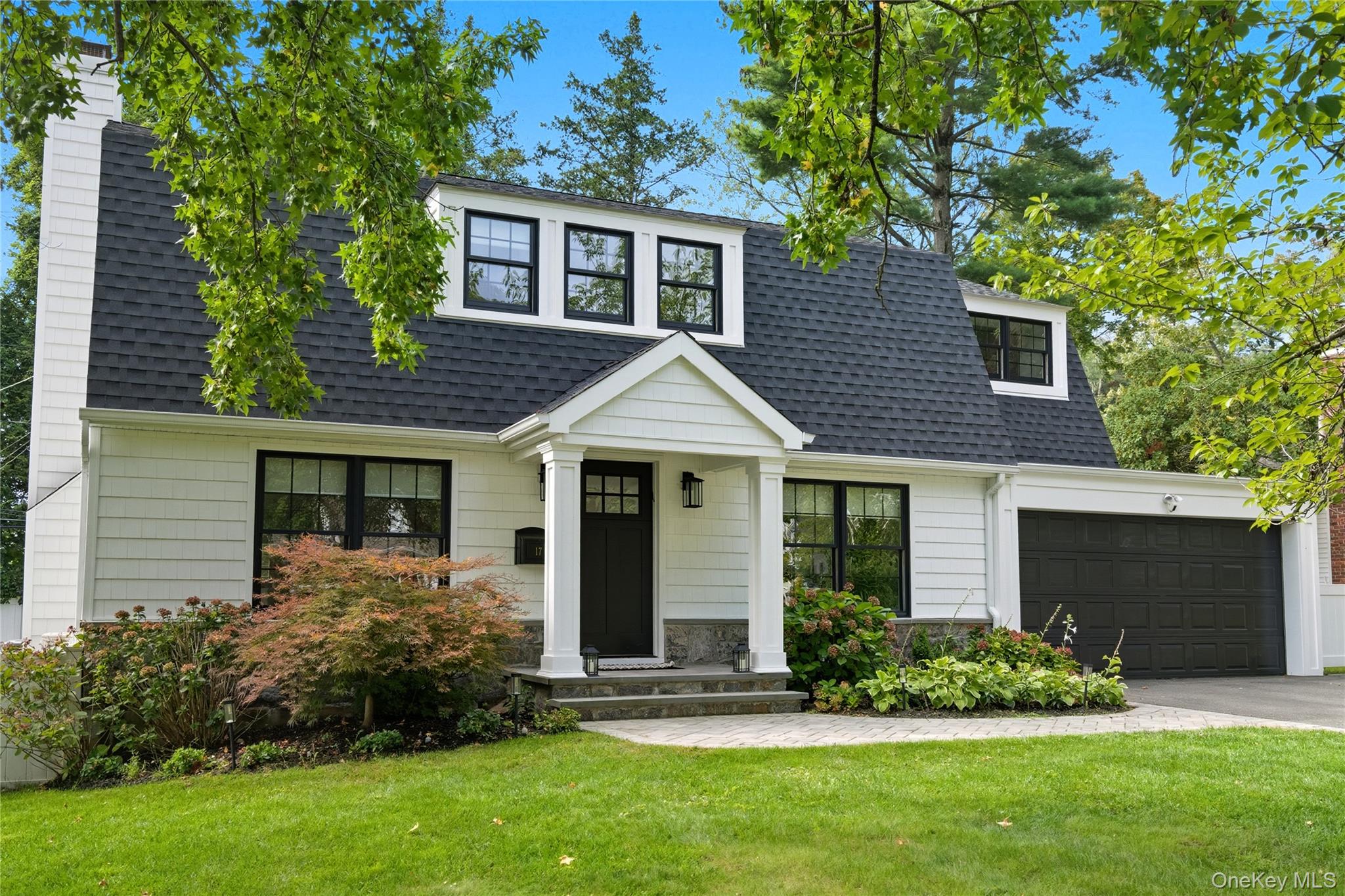 17 Entrance Road East Hills, NY 11577 - Photo 3 of 30 a front view of a house with a yard and garage