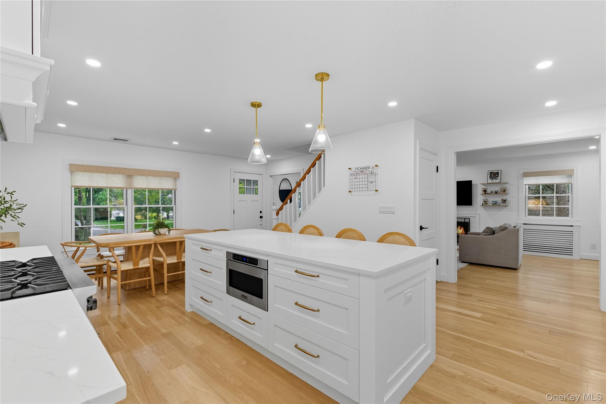 17 Entrance Road East Hills, NY 11577 - Photo 4 of 30 a large white kitchen with stainless steel appliances granite countertop a stove and a refrigerator