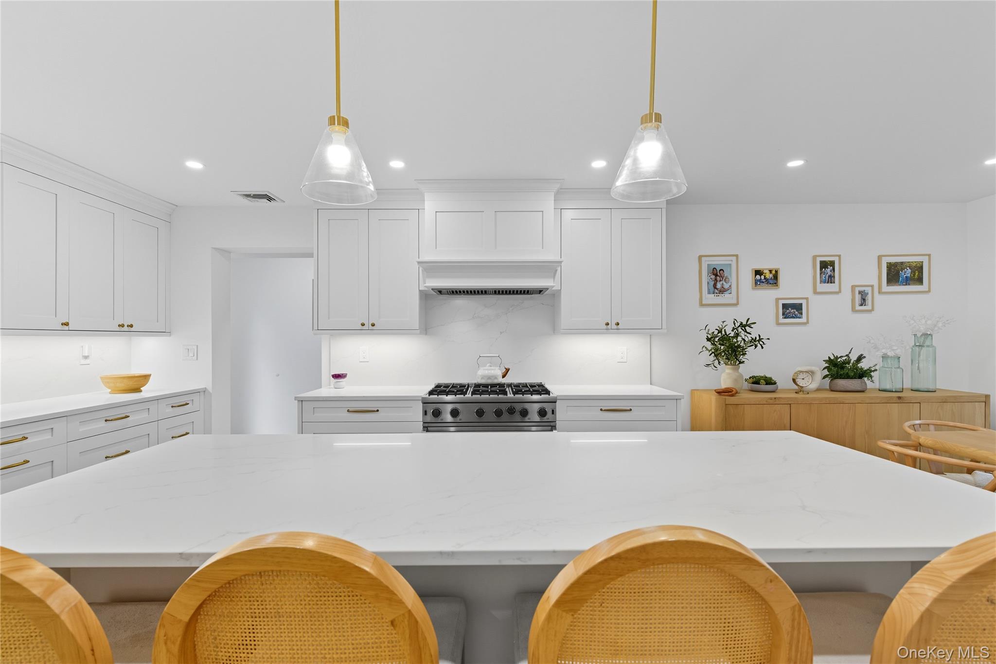 17 Entrance Road East Hills, NY 11577 - Photo 10 of 30 a kitchen with stainless steel appliances granite countertop a sink a stove a refrigerator and white cabinets