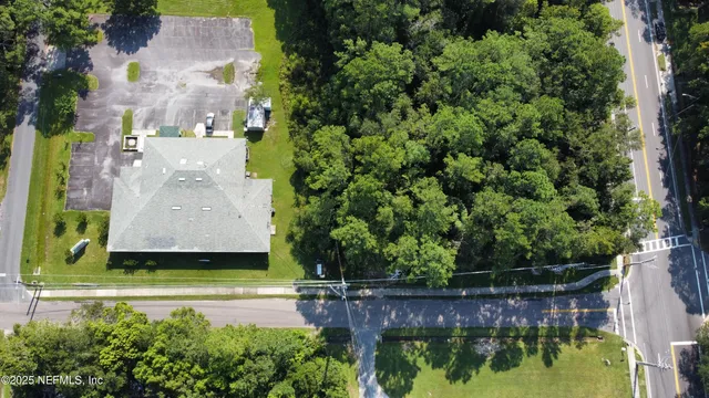an aerial view of a house with a yard