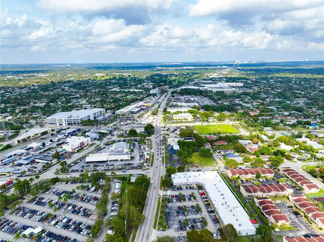 an aerial view of a house with a yard and garden