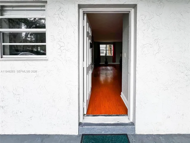 a very nice looking room with wooden floor and furniture