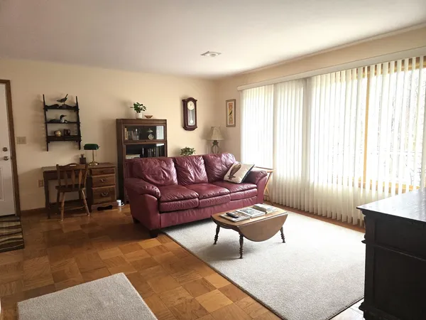 a view of a dining room with furniture and a window