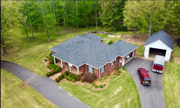 an aerial view of a house with swimming pool garden and patio