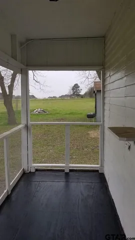 a view of water heater room with wooden floor