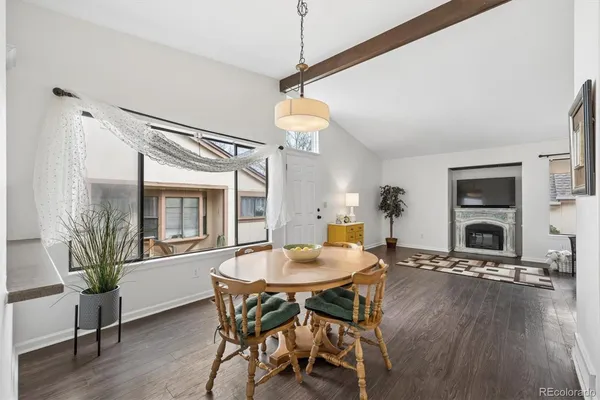 a dining room with furniture and wooden floor