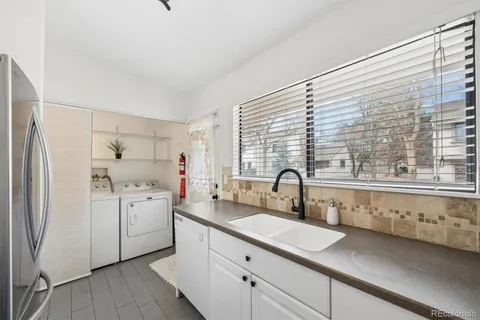 a kitchen with a sink stove and refrigerator