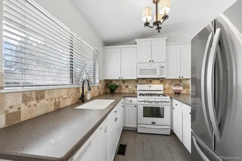 a kitchen with stainless steel appliances a stove sink and refrigerator