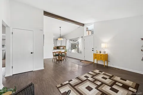 a living room with lots of furniture and wooden floor