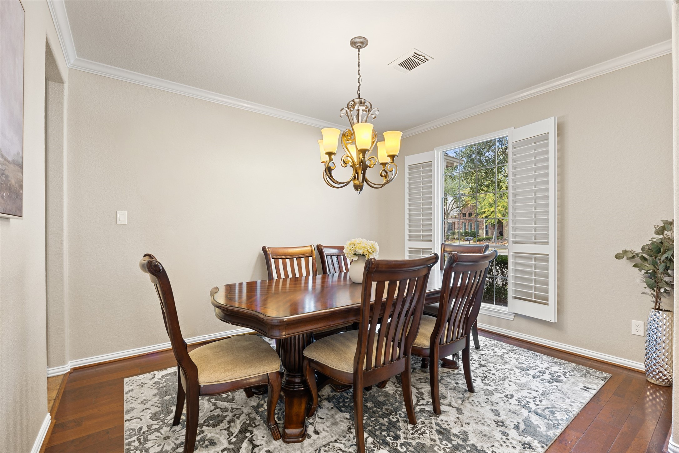 2603 Hendricks Lakes Drive Spring, TX 77388 - Photo 18 of 50 Elegant formal dining room featuring rich hardwood flooring, crown molding, and plantation shutters that provide beautiful natural light. An ideal space for hosting gatherings and holiday dinners with seamless flow from the entry and adjoining living areas.