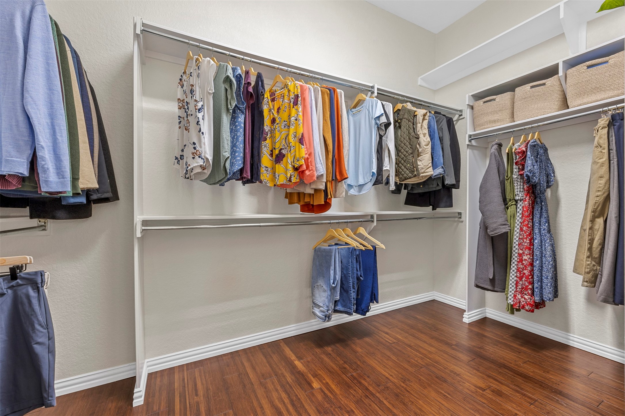 2603 Hendricks Lakes Drive Spring, TX 77388 - Photo 22 of 50 Generously sized primary walk-in closet featuring dual-level hanging rods and durable wood flooring—designed to maximize storage and efficiency
