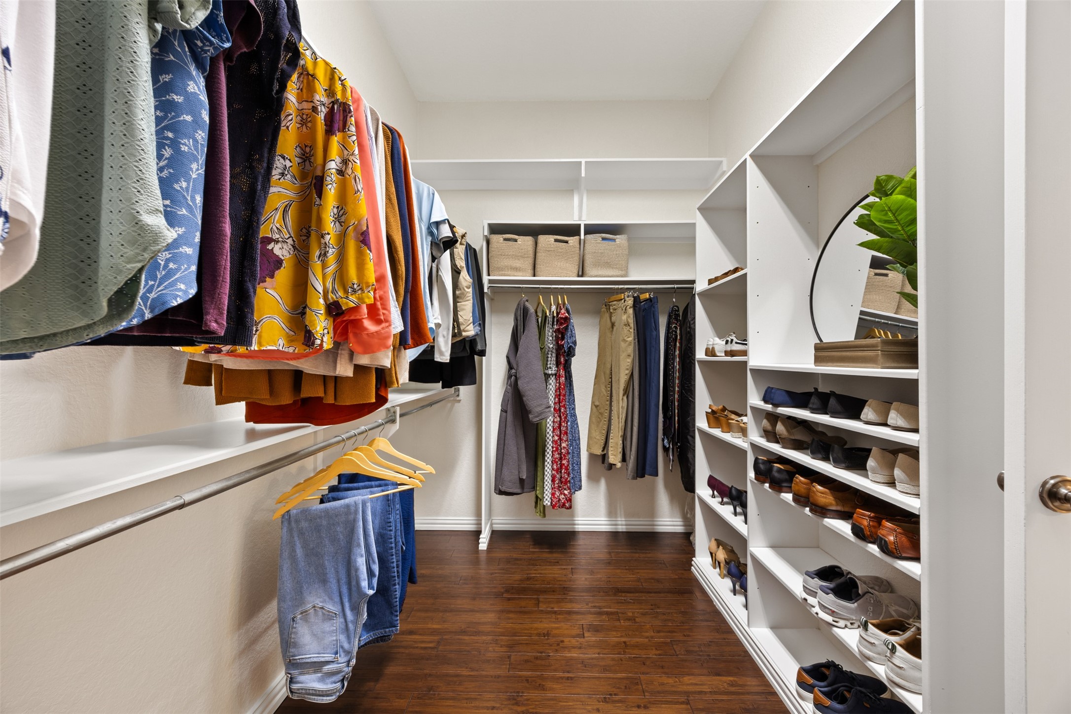 2603 Hendricks Lakes Drive Spring, TX 77388 - Photo 23 of 50 Boutique-inspired primary closet complete with custom organization system, generous hanging space, dedicated shoe display shelving, and elegant wood flooring. Designed for both style and efficiency.