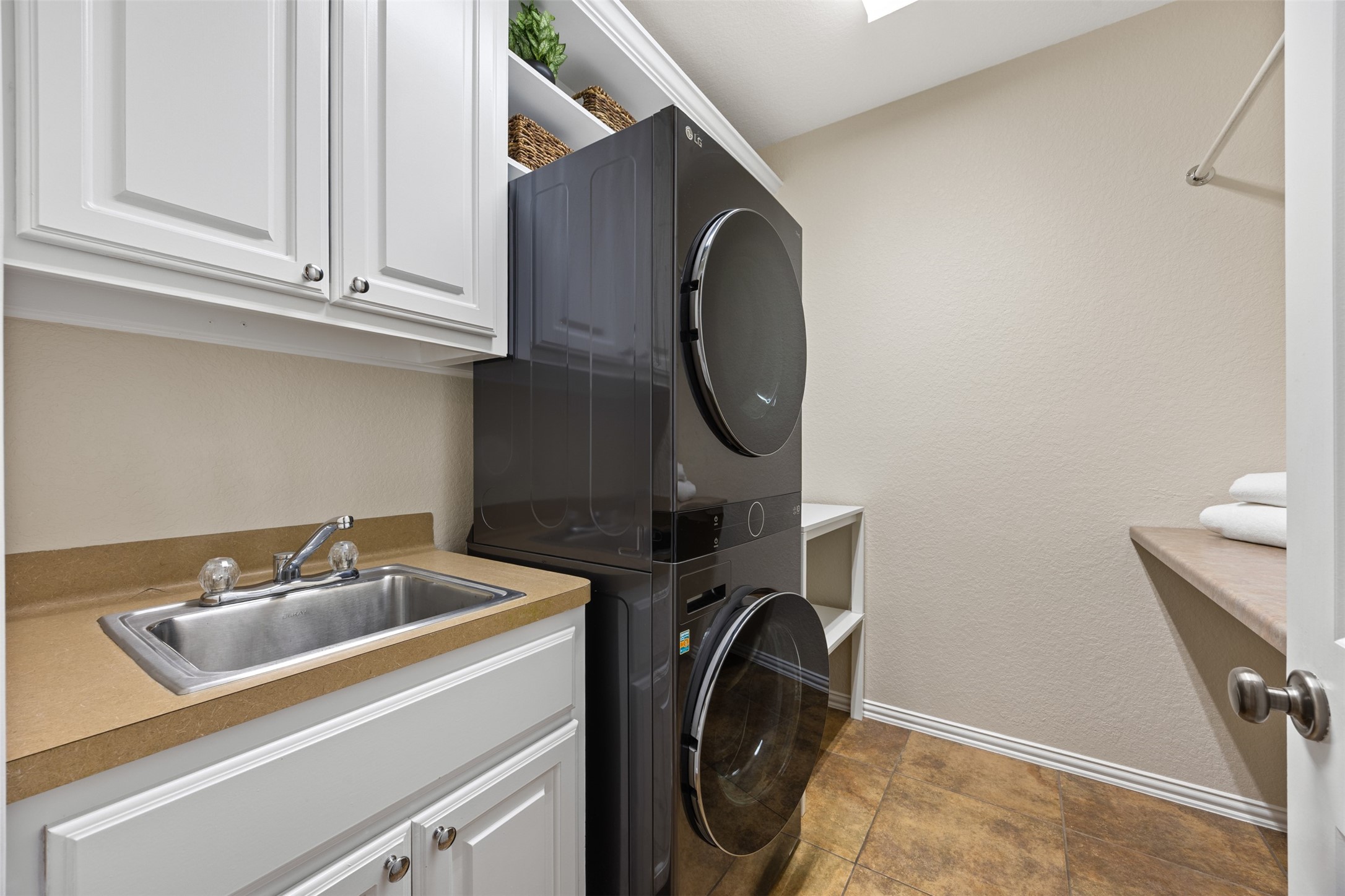 2603 Hendricks Lakes Drive Spring, TX 77388 - Photo 26 of 50 Well-appointed laundry room with upper and lower cabinetry, utility sink, and ample storage space—designed for both function and convenience.