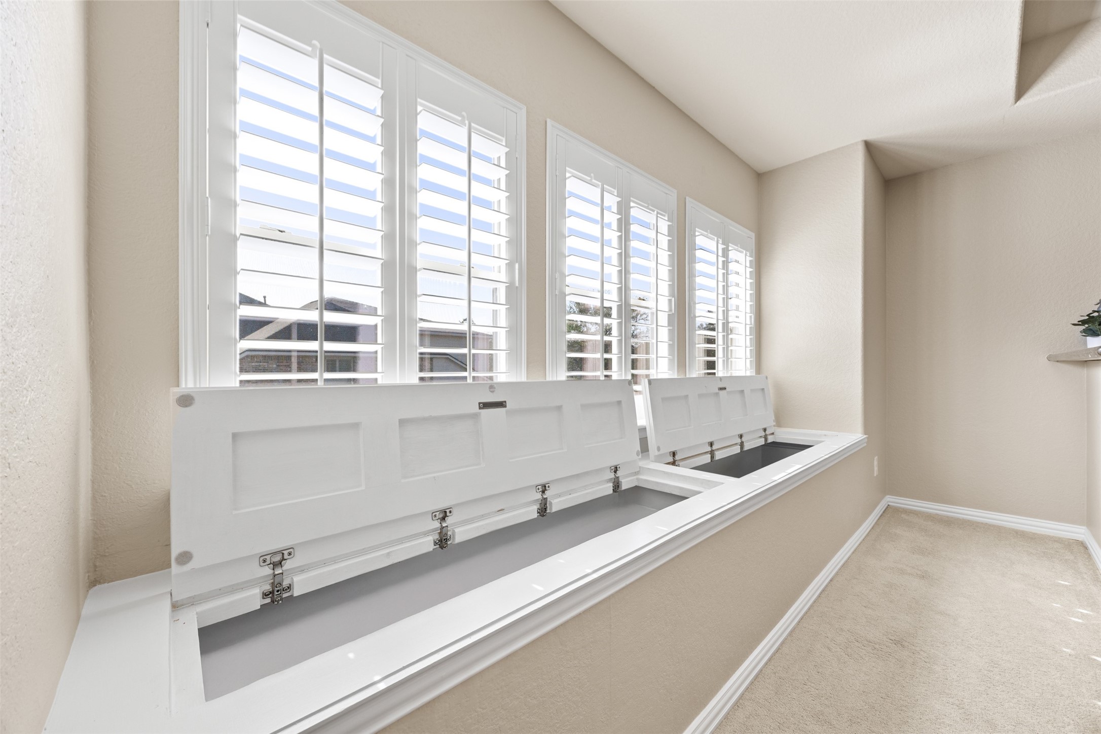 2603 Hendricks Lakes Drive Spring, TX 77388 - Photo 31 of 50 Custom window seat with concealed storage offers both charm and functionality in the upstairs game room, framed by beautiful plantation shutters.