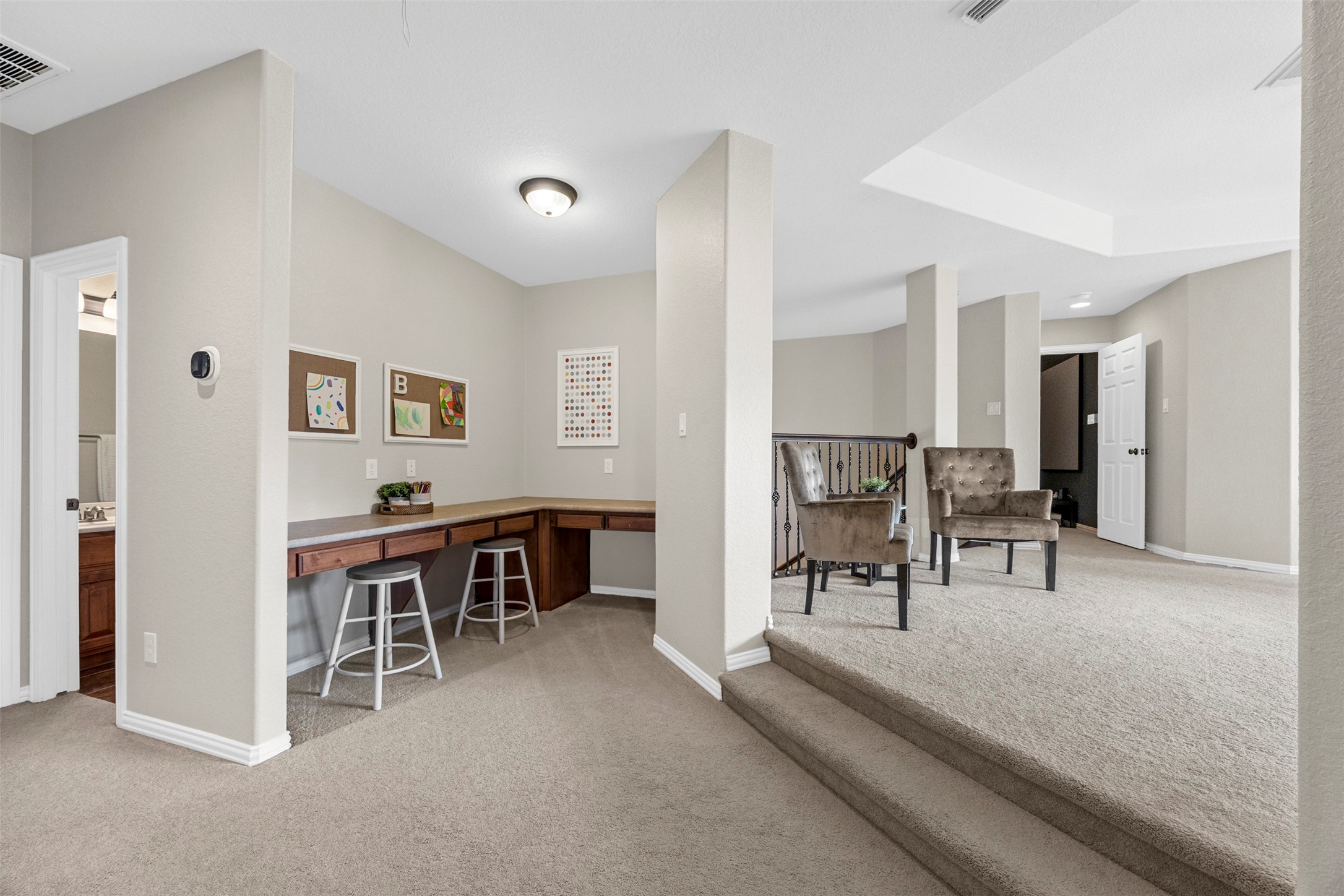 2603 Hendricks Lakes Drive Spring, TX 77388 - Photo 32 of 50 Versatile upstairs loft featuring a built-in dual desk workspace and additional sitting area—perfect for homework stations, remote work, or a secondary living space.