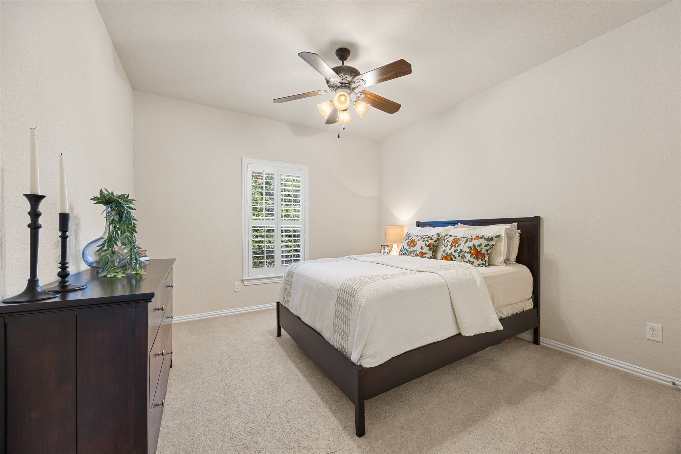2603 Hendricks Lakes Drive Spring, TX 77388 - Photo 33 of 50 Comfortable upstairs bedroom featuring neutral tones, plush carpeting, ceiling fan, and plantation shutters for added charm and privacy. A spacious secondary bedroom with excellent natural light and generous closet space.