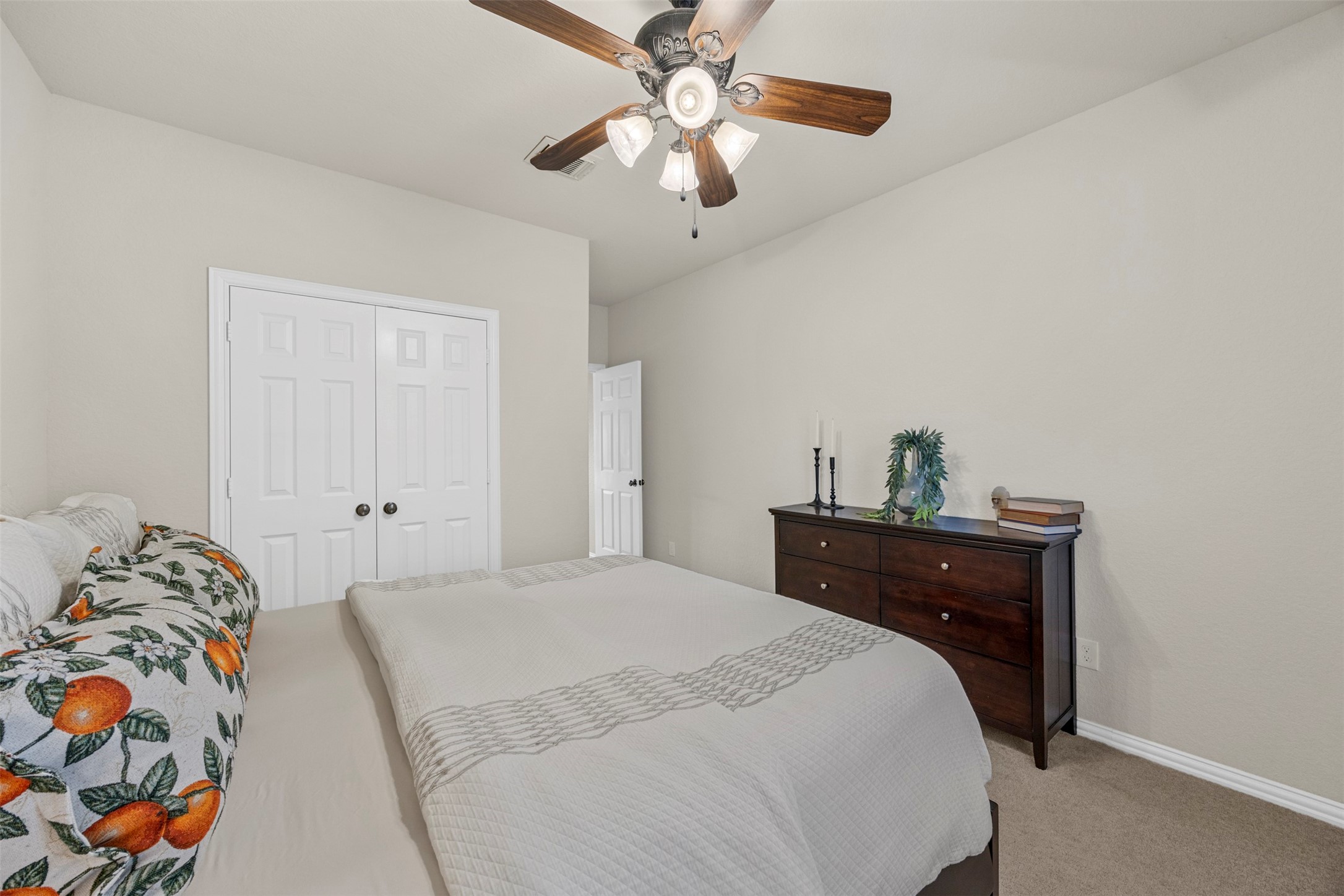 2603 Hendricks Lakes Drive Spring, TX 77388 - Photo 34 of 50 Spacious secondary bedroom featuring soft neutral finishes, ceiling fan, and ample closet storage—offering comfort and flexibility for guests or family members.