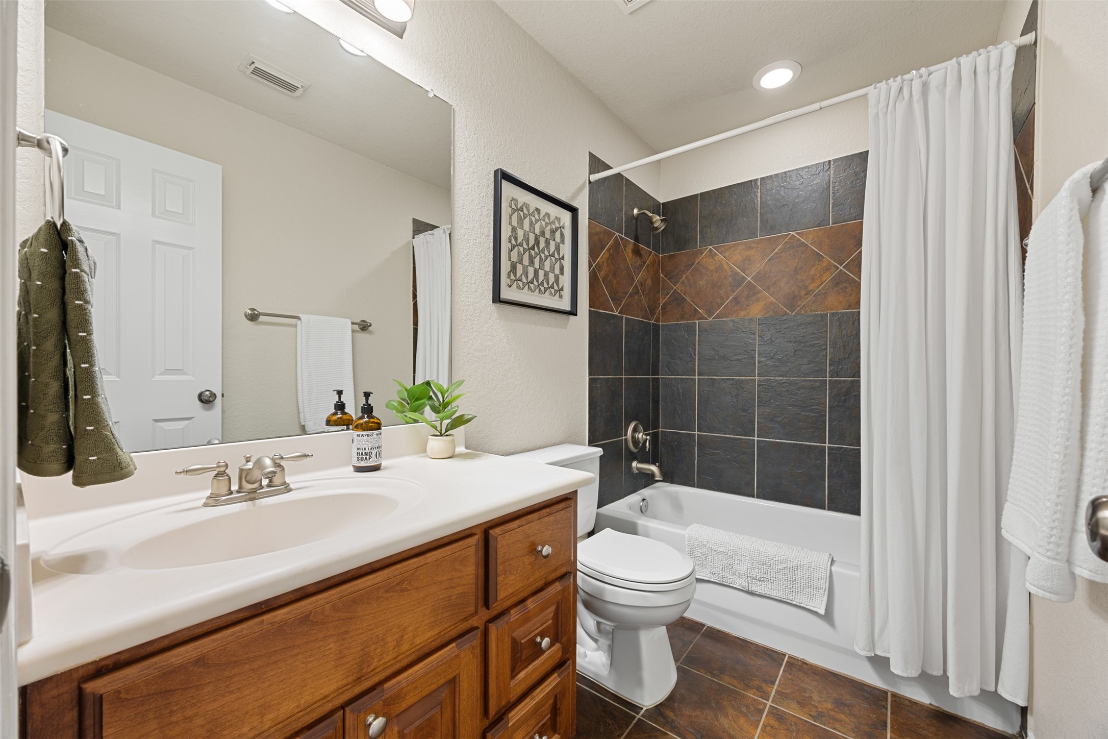 2603 Hendricks Lakes Drive Spring, TX 77388 - Photo 35 of 50 Upstairs full bath with extended vanity, abundant cabinet storage, and stylish tile tub/shower surround—designed for both comfort and convenience.