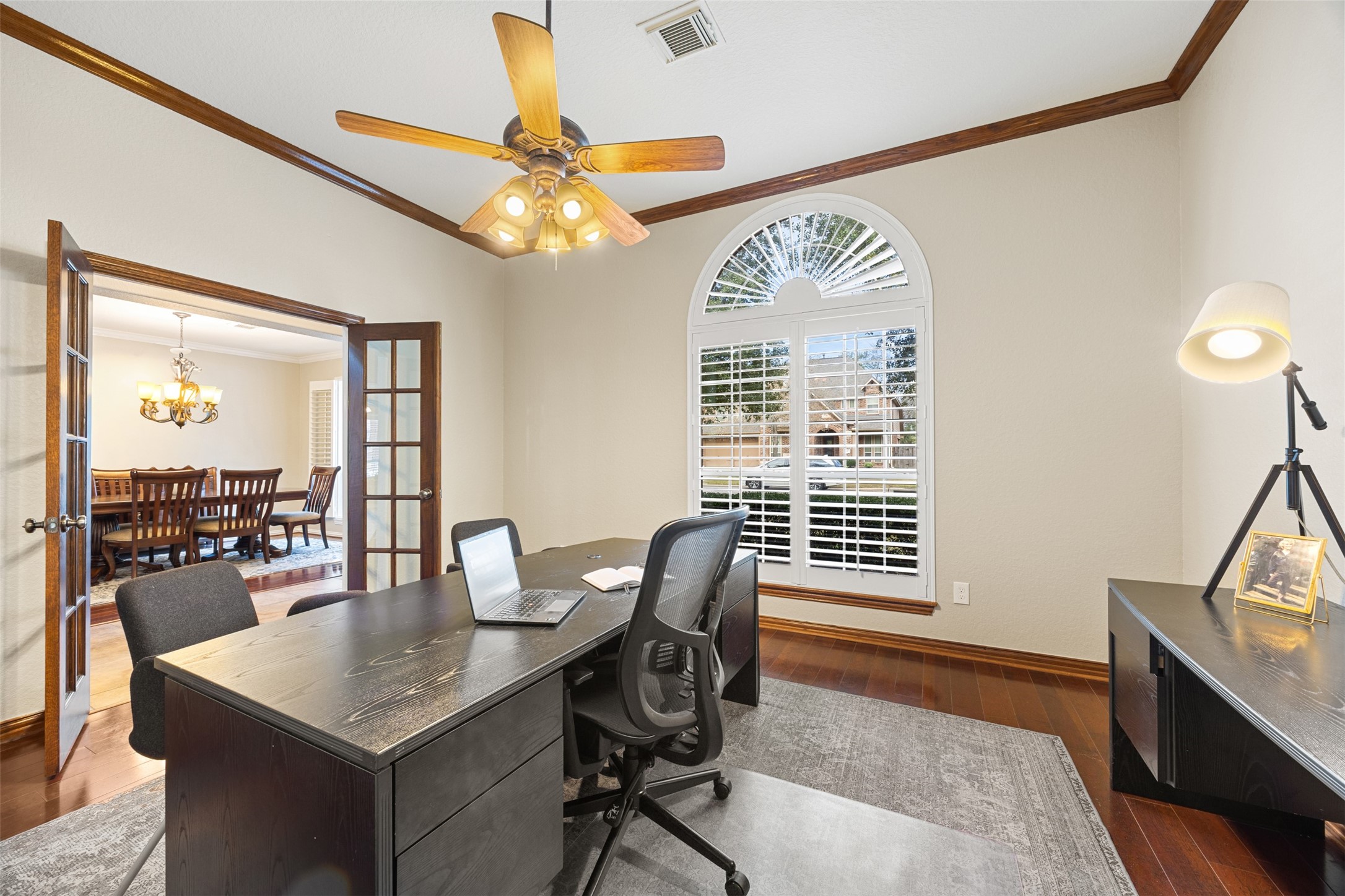 2603 Hendricks Lakes Drive Spring, TX 77388 - Photo 7 of 50 Spacious private study with hardwood flooring, crown molding, and large arched windows with plantation shutters that provide abundant natural light. Double French doors offer privacy while maintaining an open flow to the formal dining area.