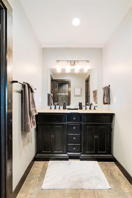 962 County Road Pattonville, TX 75468 - Photo 27 of 37 a bathroom with a sink vanity and mirror