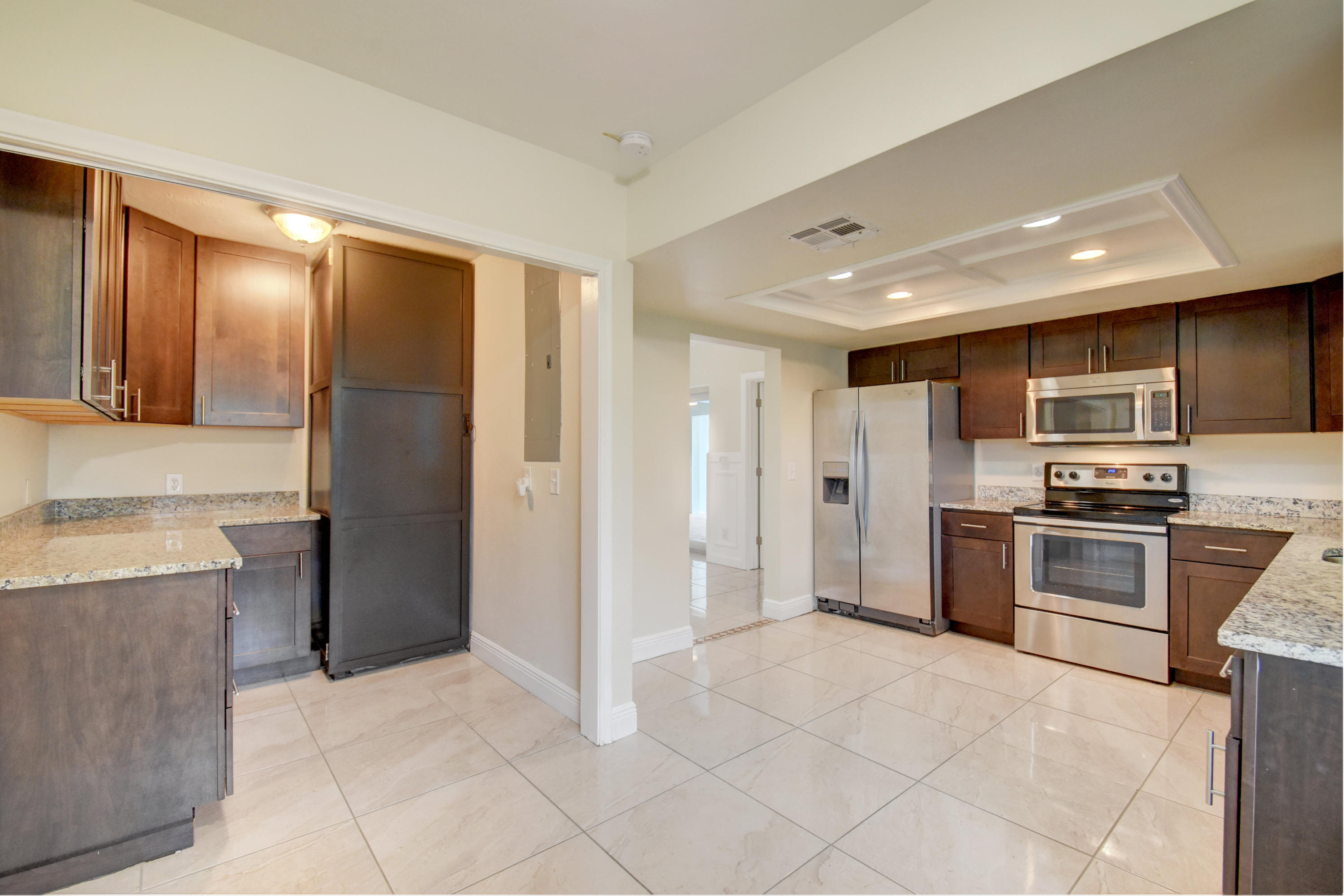 1266 Southwest 5th Street Boca Raton, FL 33486 - Photo 15 of 30 a large white kitchen with stainless steel appliances granite countertop a refrigerator and a stove top oven