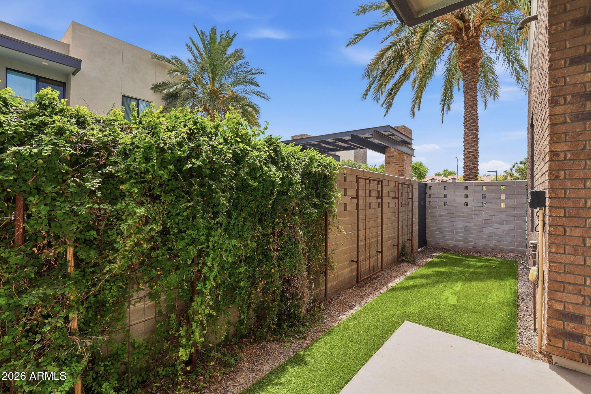 901 South Smith Road, Unit 1038 Tempe, AZ 85281 - Photo 2 of 29 a view of a backyard with a plants and a palm tree