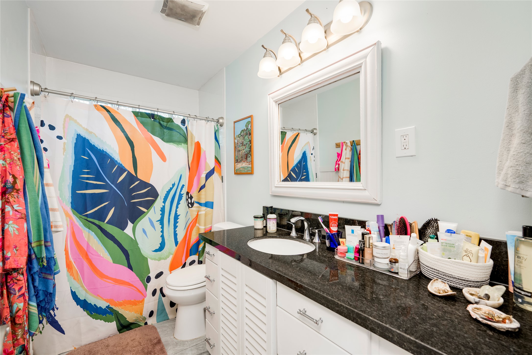 5300 Halmark Drive Austin, TX 78723 - Photo 21 of 40 A well-lit bathroom with granite counters and a clean, spacious vanity area.