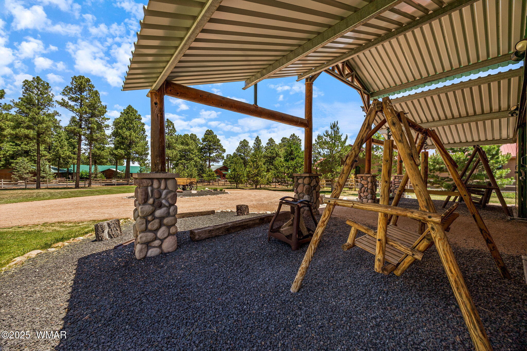2295 Bison Rnch Trail Overgaard, AZ 85933 - Photo 43 of 68 PORCH SWINGS IN FRONT OF BARN CONVEY