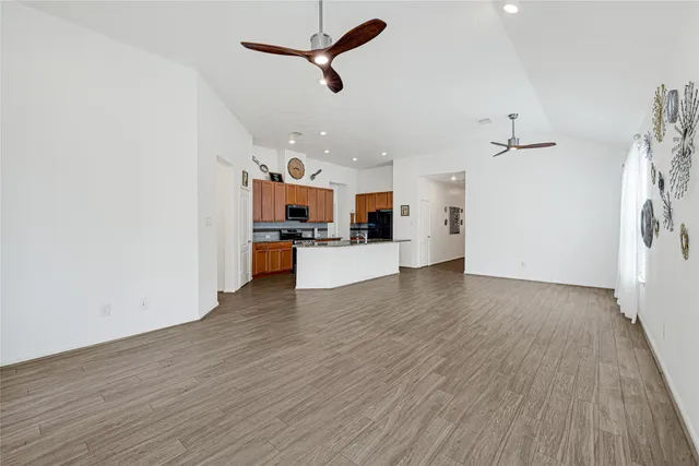 a view of a kitchen with a sink and a refrigerator