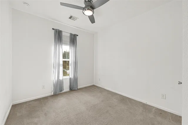 an empty room with a empty space and windows