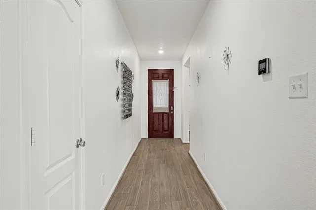 a view of a hallway with wooden floor
