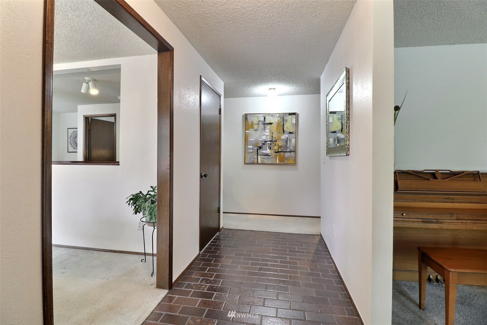 22105 2nd Place West Bothell, WA 98021 - Photo 8 of 37 a view of a hallway with wooden floor and a living room