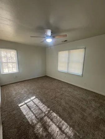 an empty room with a empty space and windows