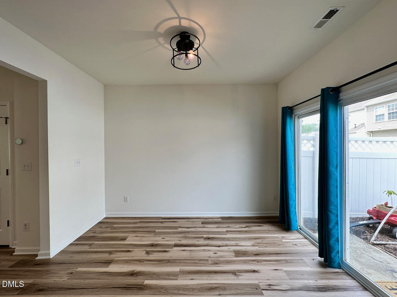 5105 Obion Court Raleigh, NC 27616 - Photo 9 of 22 a view of empty room with wooden floor and fan