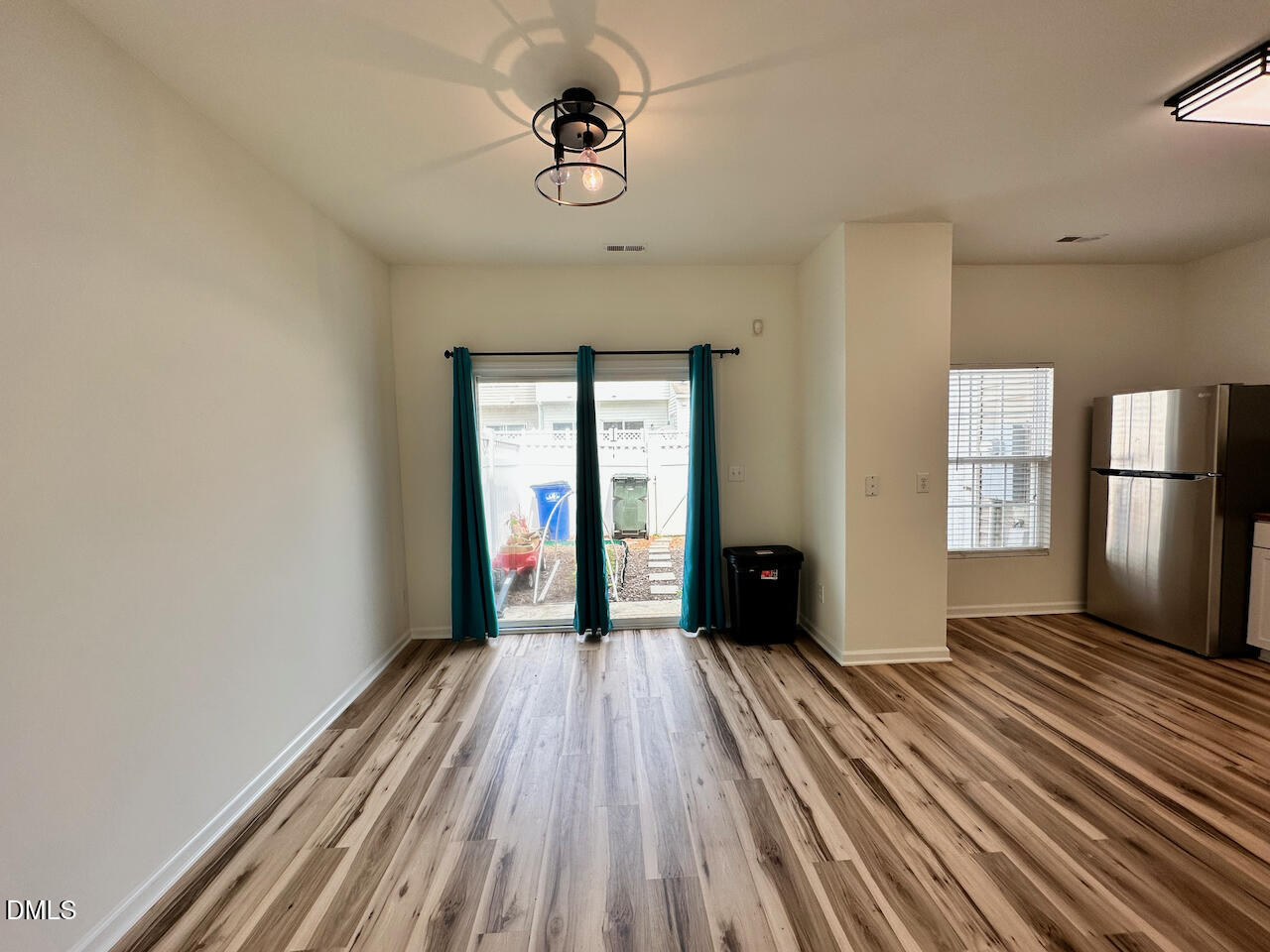 5105 Obion Court Raleigh, NC 27616 - Photo 10 of 22 a view of a room with wooden floor a ceiling fan and windows