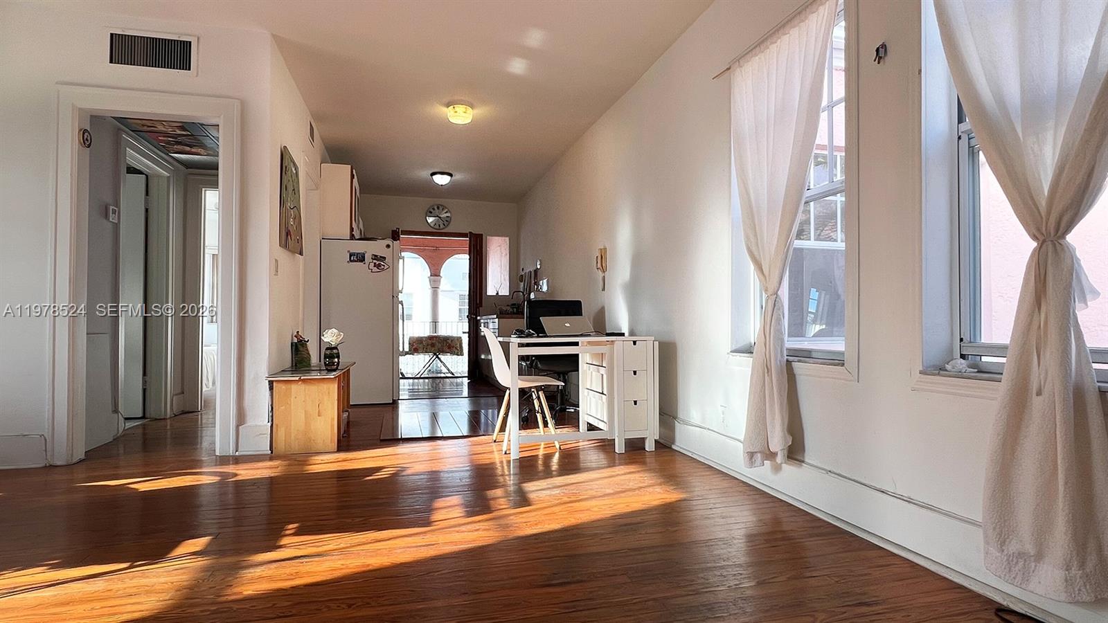 756 Meridian Avenue, Unit 10 Miami Beach, FL 33139 - Photo 1 of 9 a view of a kitchen with furniture and wooden floor